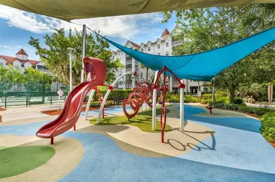 a playground with a slide and a hammock at Hilton Vacation Club Grand Beach Orlando in Orlando