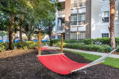 a hammock in a park in front of a building at Hilton Vacation Club Grande Villas Orlando in Orlando