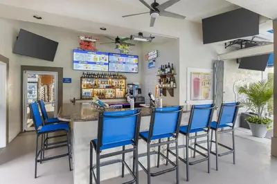 a bar with blue bar stools in a restaurant at Hilton Vacation Club Grande Villas Orlando in Orlando