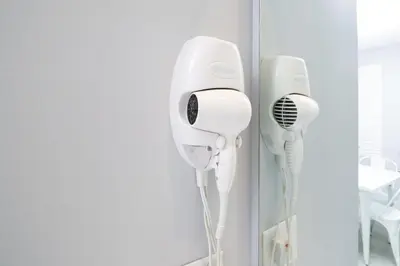 two hair dryers are hanging on a wall at Disney 12 minutes for family, Pool and parking FREE in Kissimmee