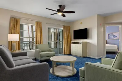 a living room with a couch and chairs and a television at Club Wyndham Cypress Palms in Kissimmee