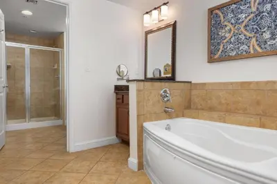 a large bathroom with a tub and a mirror at Club Wyndham Bonnet Creek in Orlando