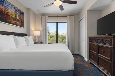 a bedroom with a large bed and a flat screen tv at Club Wyndham Bonnet Creek in Orlando