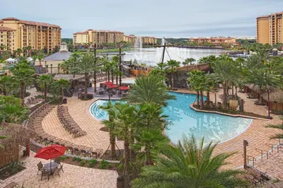 an aerial view of a resort with a pool and palm trees at Club Wyndham Bonnet Creek in Orlando