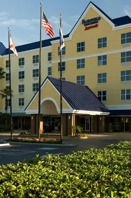 a hotel with two american flags in front of it at Fairfield Inn & Suites by Marriott Orlando Lake Buena Vista in Orlando