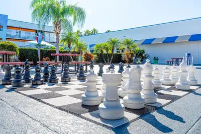 a giant chessboard on a sidewalk in front of a building at Ramada by Wyndham Flamingo Water Park in Kissimmee
