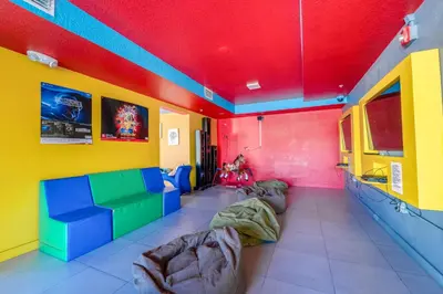 a room with colorful walls and couches at Ramada by Wyndham Flamingo Water Park in Kissimmee