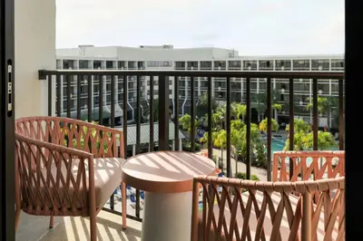a balcony with a table and chairs and a view of a building at Sheraton Orlando Lake Buena Vista Resort in Orlando