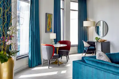 a living room with a blue couch and a table at Grand Bohemian Orlando, Autograph Collection in Orlando