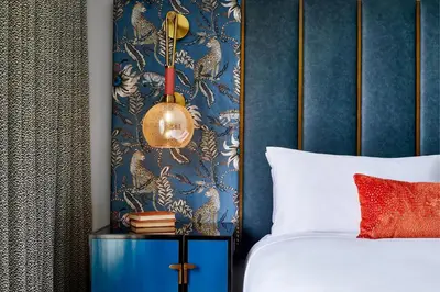 a bedroom with a bed and a blue wall at Grand Bohemian Orlando, Autograph Collection in Orlando