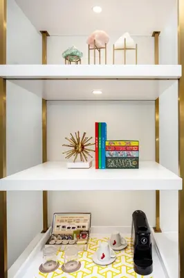a white shelf with books and other items on it at The Alfond Inn in Orlando