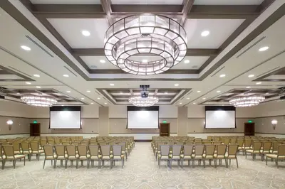 a conference room with chairs and screens in it at The Alfond Inn in Orlando