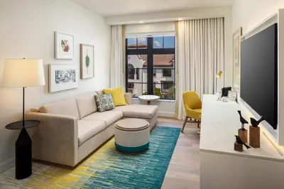 a living room with a couch and a tv at The Alfond Inn in Orlando