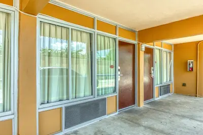 an empty house with glass doors and windows at Hotel Belair Orlando Near Florida Mall in Orlando