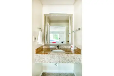 a bathroom with a sink and a mirror at Hotel Belair Orlando Near Florida Mall in Orlando