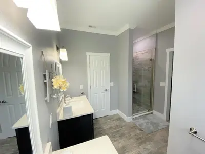 a bathroom with a sink and a shower at Mickeys Pearl - Phenomenal 7BR with 4 Master Suites Privacy Pool & Hot Tub Gas BBQ - 2 miles to Disney in Orlando