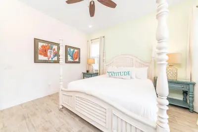 a white bedroom with a white bed and a ceiling fan at Sunrise Cottage Near Disney With Margaritaville Resort & Island H20 Waterpark Access - 2988Sr in Orlando