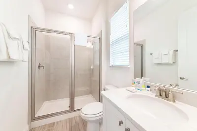 a bathroom with a shower and a toilet and a sink at Sandcastles & Sunshine Cottage With Private Pool Near Disney With Margaritaville Resort & Island H20 Access - 8025Su in Orlando