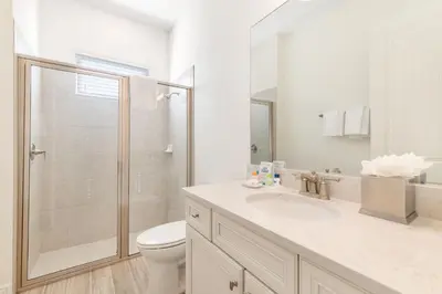 a bathroom with a shower and a toilet and a sink at Salt Water Cottage Near Disney With Margaritaville Resort & Island H2O Access - 8012Dr in Orlando