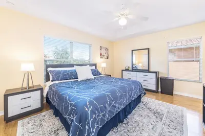 a bedroom with a bed and a ceiling fan at Lovely Disney Vacation House in Orlando