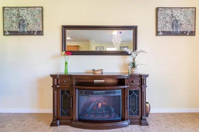 a fireplace in a living room with a mirror at Lovely Disney Vacation House in Orlando