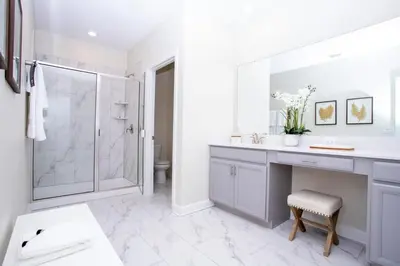 a bathroom with a shower and a sink and a mirror at Gorgeous 5 Bd Single Family Close to Disney @ Storey Lake Resort 2734 in Kissimmee