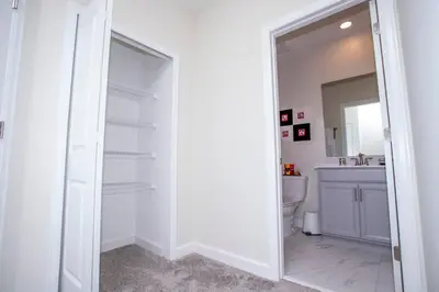 a bathroom with a mirror and a toilet and a sink at Gorgeous 5 Bd Single Family Close to Disney @ Storey Lake Resort 2734 in Kissimmee