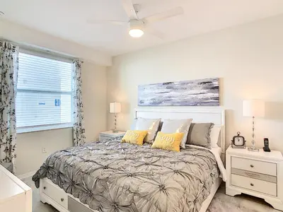 a bedroom with a bed and a window at Lakeview Themed 2BR Condo with Waterpark Access in Kissimmee