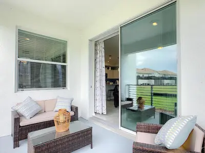 a living room with a couch and a table at Lakeview Themed 2BR Condo with Waterpark Access in Kissimmee