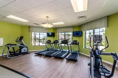 a gym with treadmills and elliptical machines at Lakeview Themed 2BR Condo with Waterpark Access in Kissimmee