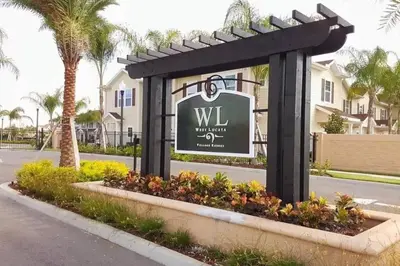 a sign for a villa with palm trees at Great townhouse in great luxurious community, poolgym Close to Disney! in Kissimmee