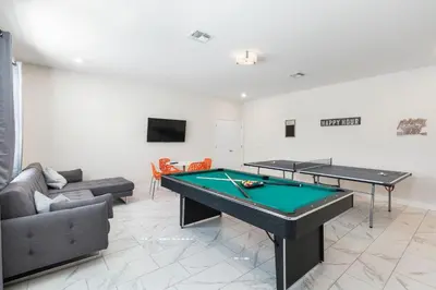 a living room with a pool table and a couch at 2957 FS - Luxury Oasis: 6BR Villa Pool Game in Kissimmee