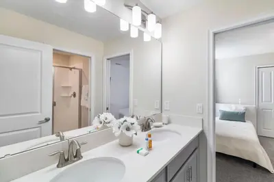 a bathroom with two sinks and a large mirror at 2957 FS - Luxury Oasis: 6BR Villa Pool Game in Kissimmee