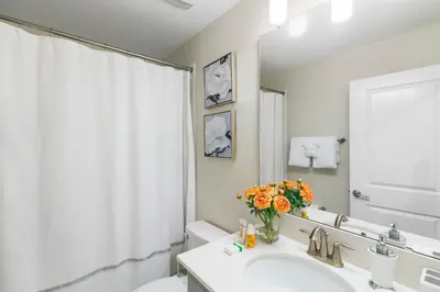 a bathroom with a sink and a vase of flowers at 2957 FS - Luxury Oasis: 6BR Villa Pool Game in Kissimmee