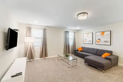 a living room with a couch and a tv at 2957 FS - Luxury Oasis: 6BR Villa Pool Game in Kissimmee