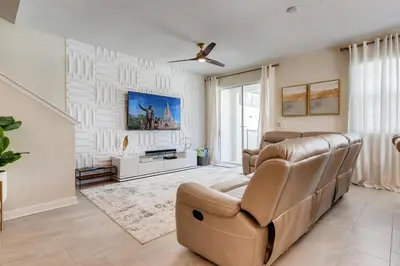 a living room with a couch and a ceiling fan at 4801 ML - Ideal Retreat Townhome Oasis with Pool in Kissimmee