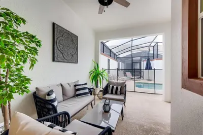 a living room with a couch and chairs and a table at 4808 LL Magical 4BR Disney Townhome Pool in Kissimmee