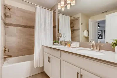 a bathroom with two sinks and a tub and a shower at 4808 LL Magical 4BR Disney Townhome Pool in Kissimmee