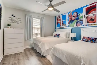 a bedroom with two beds and a ceiling fan at 4808 LL Magical 4BR Disney Townhome Pool in Kissimmee