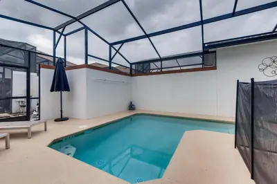 an indoor swimming pool with a glass ceiling at 4808 LL Magical 4BR Disney Townhome Pool in Kissimmee