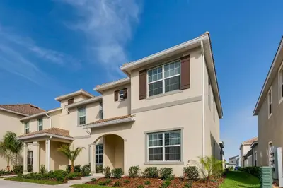 a large white house with landscaping at 4825 LL - Storey Lake in Kissimmee
