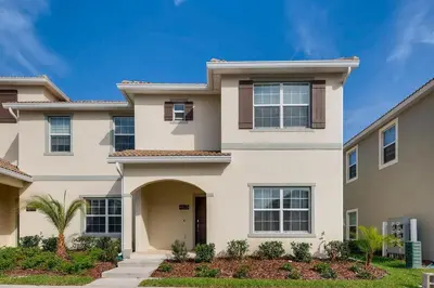 a villa with a driveway in front of a house at 4825 LL - Storey Lake in Kissimmee
