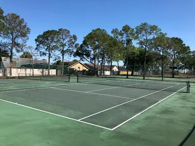a tennis court with two tennis courts at Laguna Villas in Kissimmee