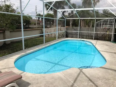 a large swimming pool in a backyard at Laguna Villas in Kissimmee