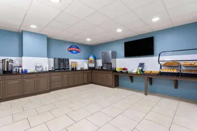 a fast food restaurant with a counter with food at Baymont by Wyndham Orlando-International Dr-Universal Blvd in Orlando