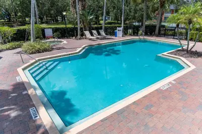 a large blue swimming pool with chairs around it at Legacy Vacation Resorts - Disney and Lake Buena Vista in Orlando
