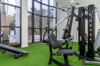 a gym with green carpet and a tread machine at Legacy Vacation Resorts - Disney and Lake Buena Vista in Orlando