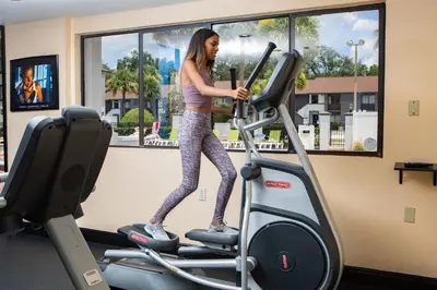 a woman on a treadmill in a gym at Legacy Vacation Resorts Kissimmee & Orlando - Near Disney in Kissimmee