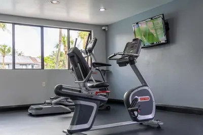 a gym with two tread machines and a flat screen tv at Legacy Vacation Resorts Kissimmee & Orlando - Near Disney in Kissimmee