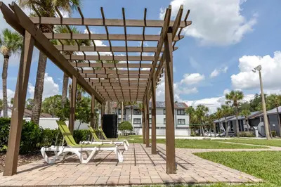 a wooden pergola with two lounge chairs on a patio at Legacy Vacation Resorts Kissimmee & Orlando - Near Disney in Kissimmee